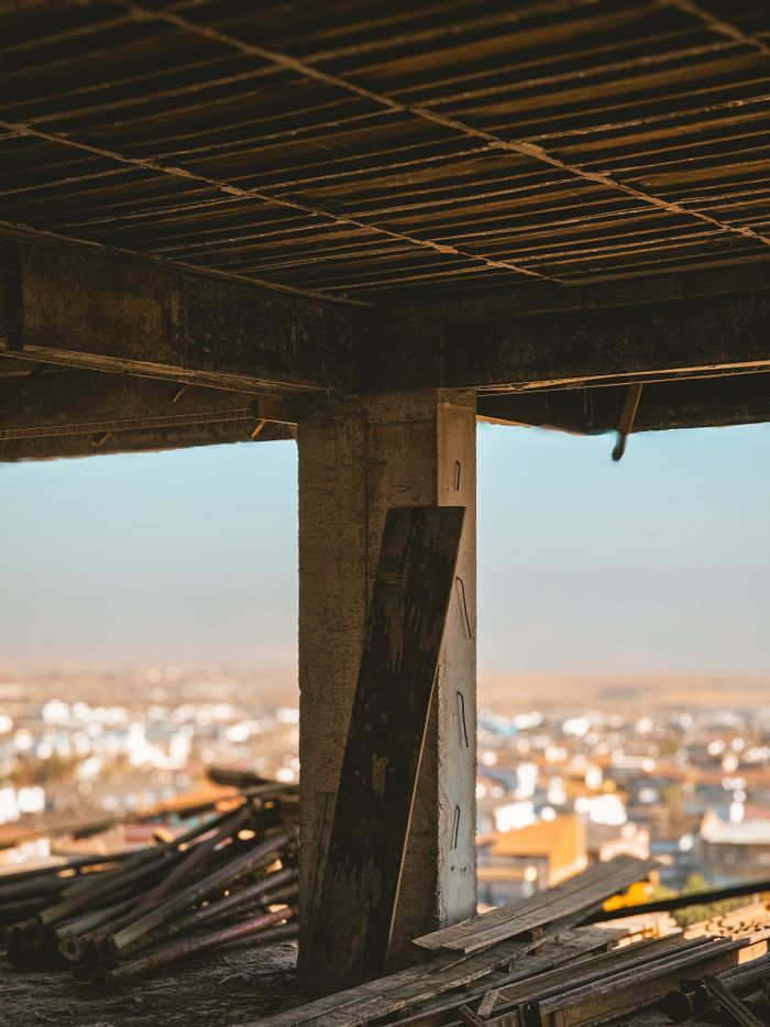 Rustic construction site with cityscape view, perfect for urban development themes.